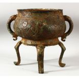 A LARGE CHINESE ARCHAIC STYLE BRONZE TWIN HANDLE CENSER, supported on four feet, the bowl with