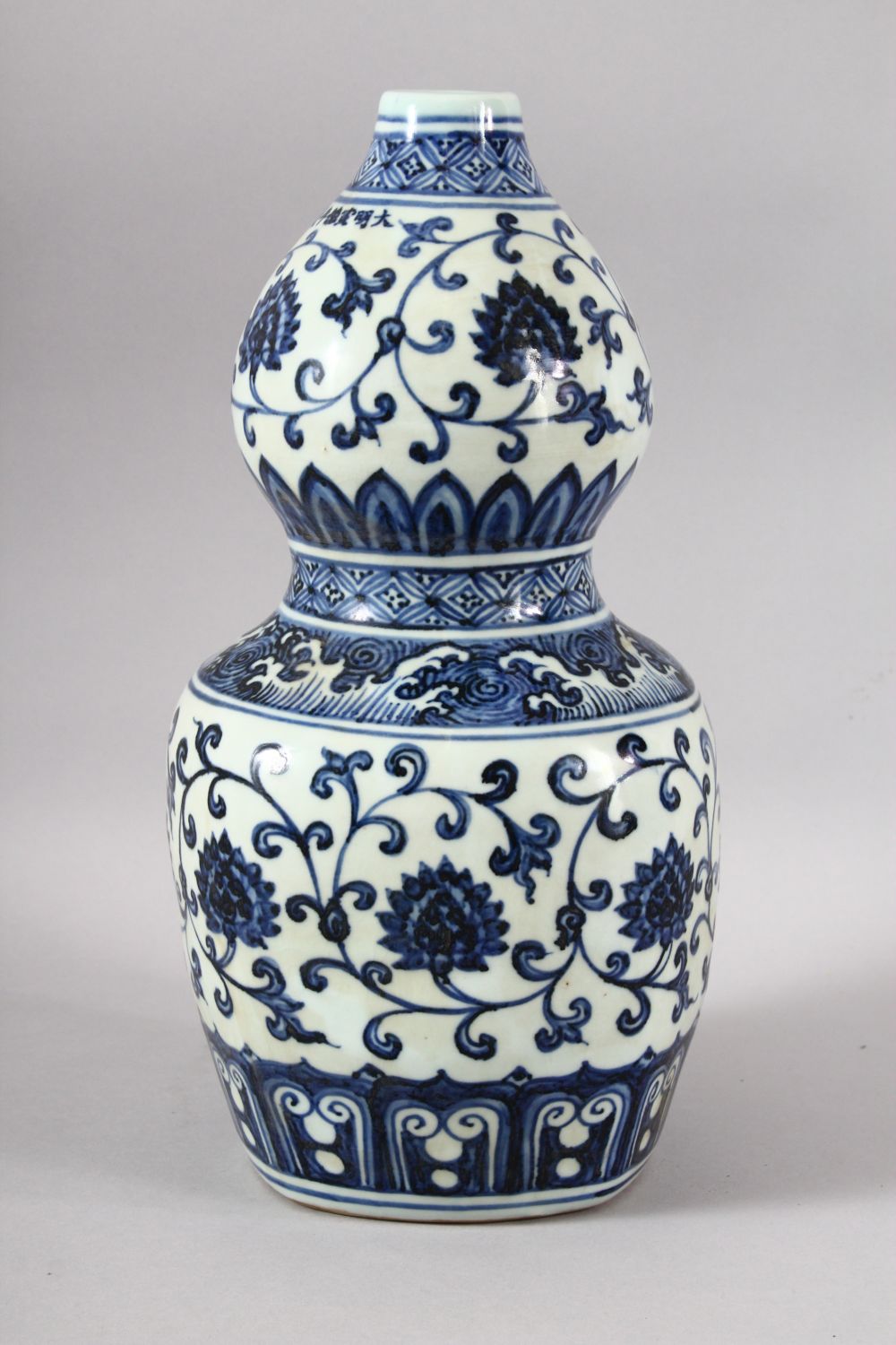 A CHINESE BLUE AND WHITE DOUBLE GOURD VASE, painted with lotus flowers, six character mark to rim, - Image 3 of 7