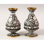 A PAIR OF ISLAMIC BLACK GROUND ENAMEL VASES, each decorated with a black ground and white raised