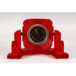 A RARE ART DECO DESIGN RED BAKELITE DESK CLOCK, 19cm wide.