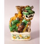 A 19TH CENTURY CHINESE SANCAI STYLE GLAZED LION DOG CANDLESTICK - in the form of a lion dog upon a