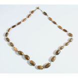 A HORN BEAD NECKLACE, possibly rhino horn, comprising 26 graduating beads, largest bead approx