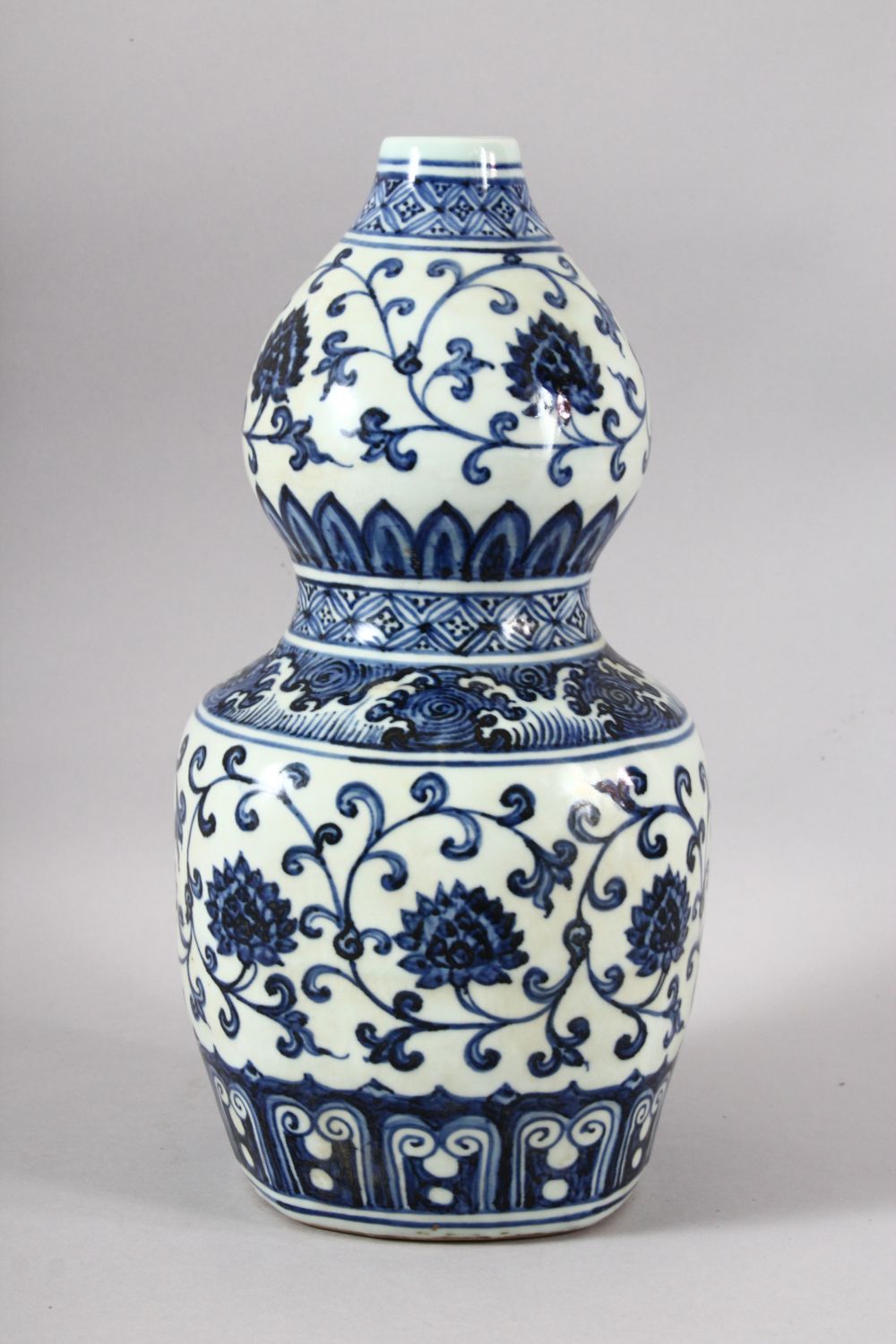 A CHINESE BLUE AND WHITE DOUBLE GOURD VASE, painted with lotus flowers, six character mark to rim, - Image 2 of 7