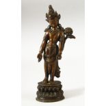 A SMALL INDIAN BRONZE FIGURE OF A DEITY, the head dress inset with small turquoise beads, fixed upon