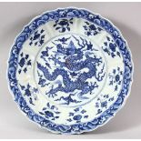 A GOOD LARGE CHINESE BLUE AND WHITE DRAGON DISH, the centre painted with a dragon amongst stylised