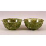 A GOOD PAIR OF CHINESE JADE BOWLS, the sides carved with ho-ho birds and stylised clouds, 15.5cm