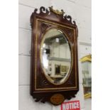 A Georgian style inlaid and carved mahogany fretwork framed mirror.