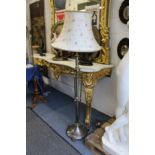 A brass and lacquered steel classical style floor standing lamp.