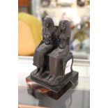 An Egyptian revival paperweight modelled as two seated figures.