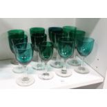 Twelve early 20th century green glass drinking glasses.