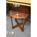 An Art Nouveau circular occasional table with embossed copper top.