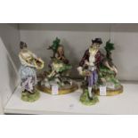 Two pairs of decorative porcelain figure groups.