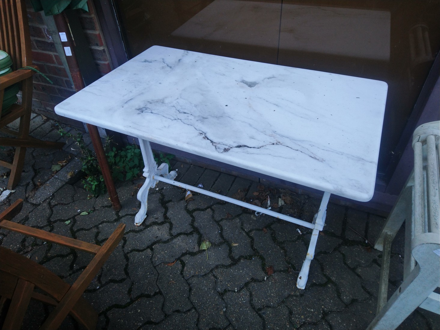 A cast iron and marble top table.