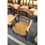 A 19th century beech and elm kitchen armchair.