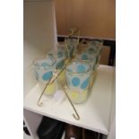 A 1970's set of eight lemonade glasses with glass carrier.