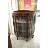 A mahogany bow fronted display cabinet.