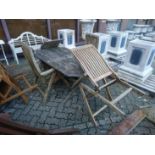 A garden table and four folding armchairs.