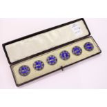 A cased set of six enamel buttons.