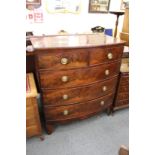 A large mahogany bow front chest of drawers.