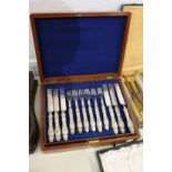A cased set of eighteen silver handled dessert knives and forks.