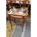 A good Edwardian mahogany bijouterie table of shaped outline with inlaid decoration.