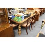 A good early 20th century Indian teak extending dining table with one leaf on barley twist legs.