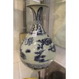 A large Chinese blue and white bottle vase painted with a dragon chasing the flaming pearl of