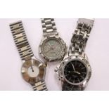 Three stainless steel designer wristwatches.