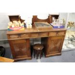 An early 20th century Indian teak pedestal sideboard with upper section over three frieze drawers