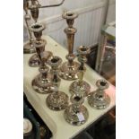 Three pairs of plated candlesticks.