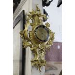 A gilt metal Cartel style wall clock.