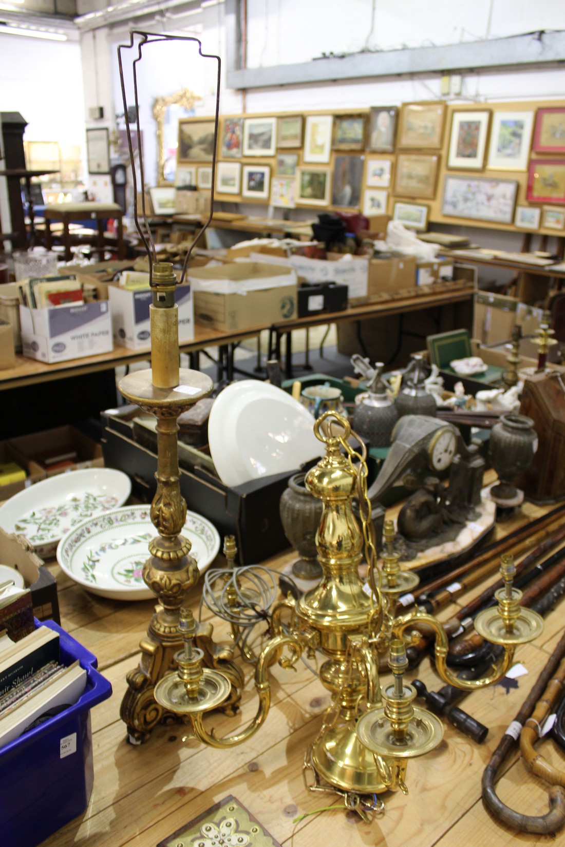 A large brass five branch chandelier and a gilt plaster lamp.