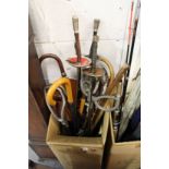 A collection of walking sticks, umbrellas, fencing foils.