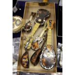 A good collection of tortoiseshell miniature mandolins and guitars.