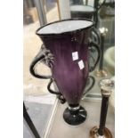 A large amethyst glass vase.