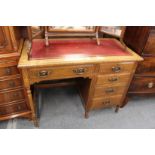 An Edwardian oak single pedestal desk.