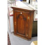 A 19th century oak hanging corner cabinet.