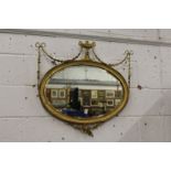 An Adam's revival gilt framed oval wall mirror.