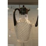 A silver mounted cut glass claret jug.