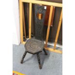 A carved oak spinning chair.