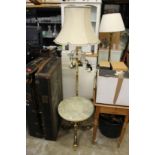 An onyx and brass occasional table and similar standard lamp.