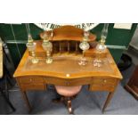 A Sheraton revival inlaid mahogany serpentine fronted desk.