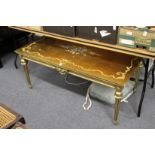 A decorative gilt wood coffee table.