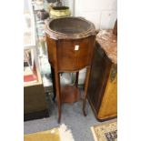 An Edwardian mahogany jardiniere stand with copper liner.