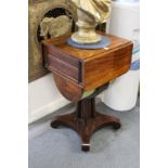 A good Regency rosewood drop flap sewing table on cluster column support with concave sided base.