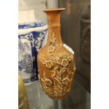 A Chinese bottle vase with moulded prunus decoration.