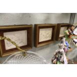 A set of three classical style plaques with gilt frames.