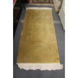 A Chinese gold ground rug.