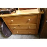 A pine three drawer chest.