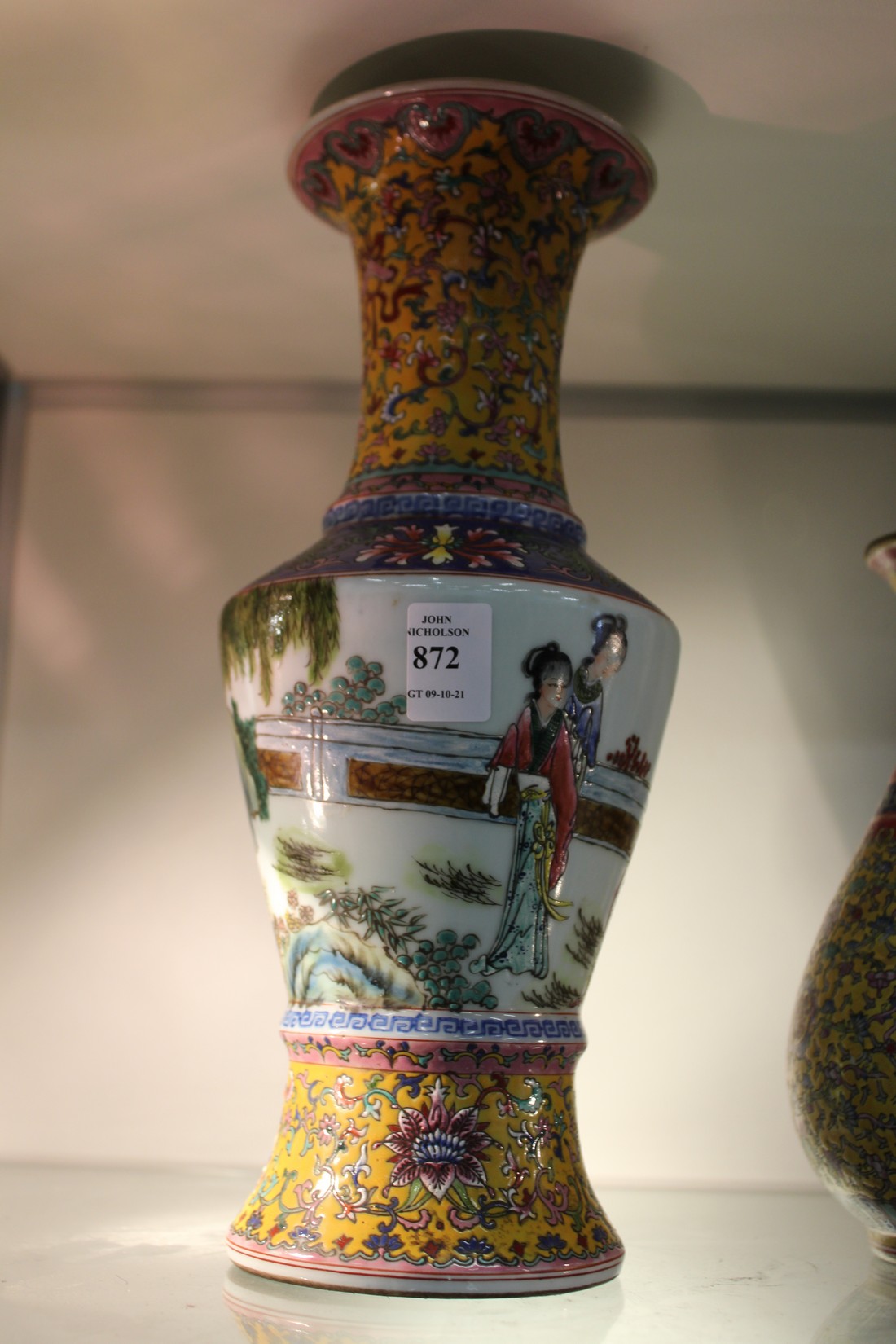 A Chinese Famille Jaune baluster shaped vase, the body decorated with female figures.